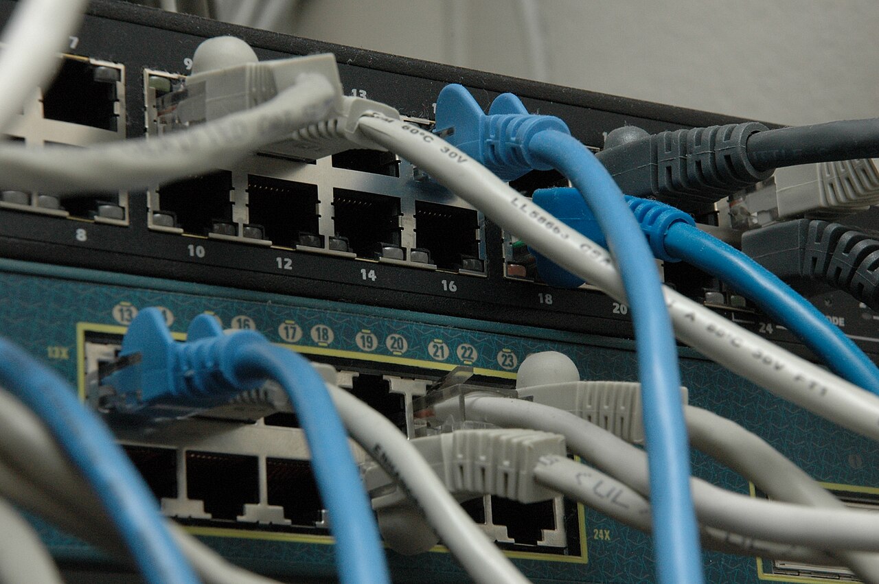 Rack-mounted network switches with illuminated port indicators and organized cabling